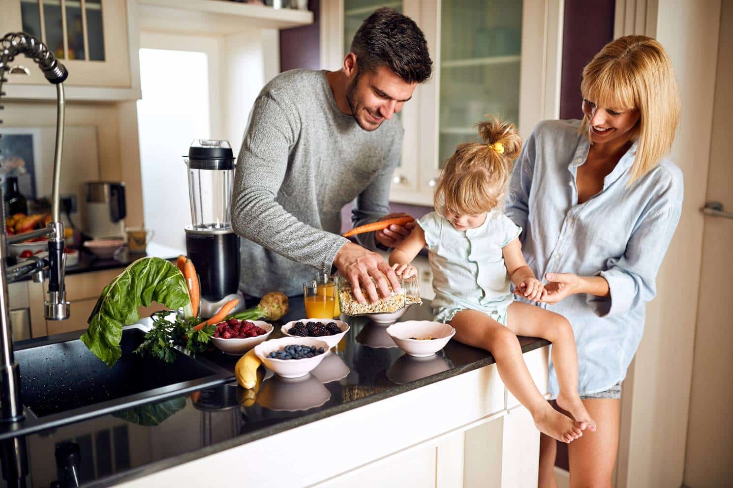 happy parents daughter snacking kitchen island 2