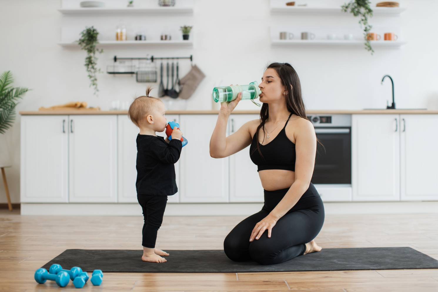 mom toddler workout drinking water