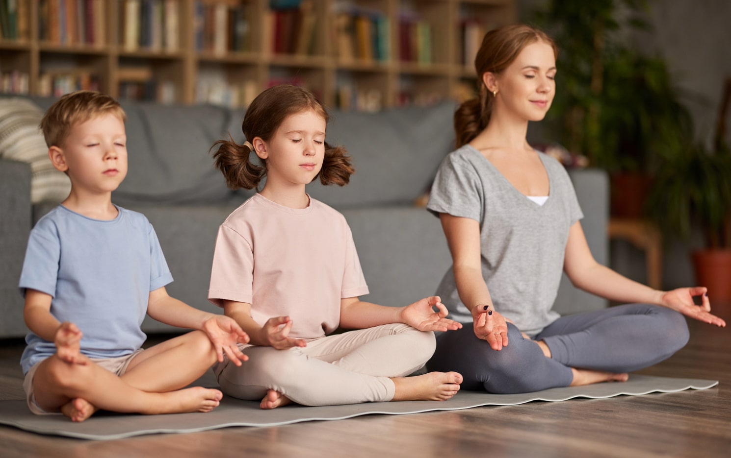 momo and kids in lotus position on floor clean air